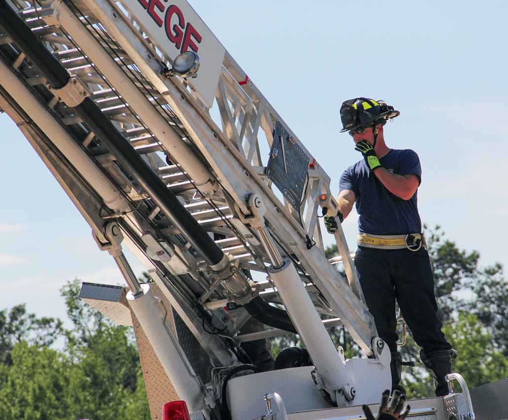 Single firefighter operating crane.