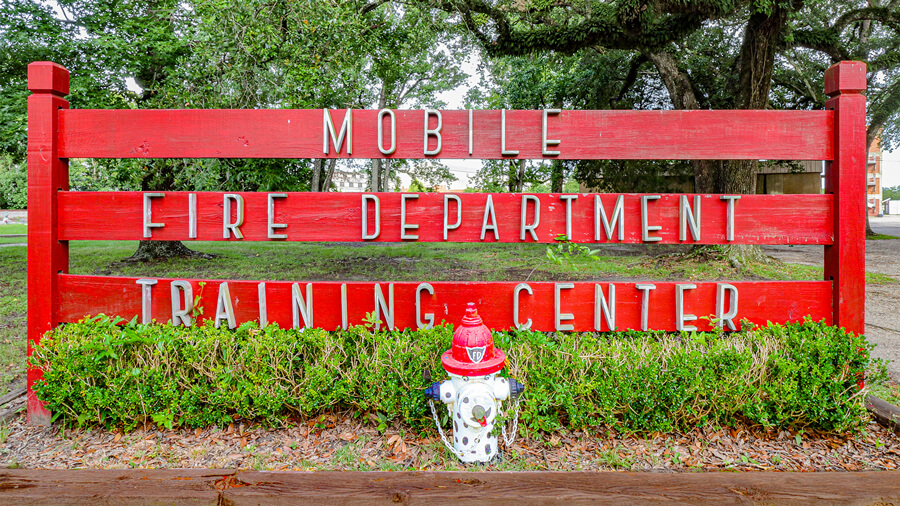 Exterior red wood sign at the Mobile Regional Training Center